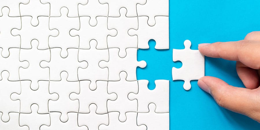 UK Wealth Tax Blog Image 01 A plain white puzzle with one piece removed, set against a light blue background—symbolising the complexity and missing pieces in the UK wealth tax debate.
