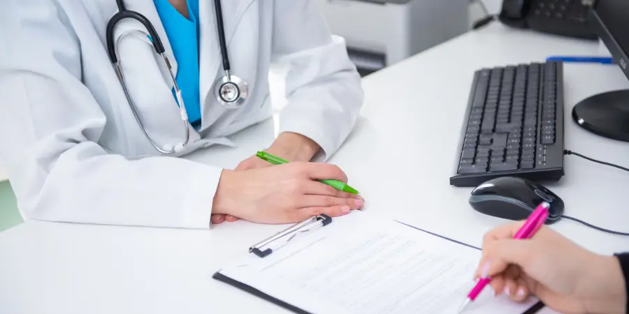 Healthcare Options for U.S. Retirees Living Overseas Healthcare professional assisting a U.S. retiree with medical insurance forms at a desk