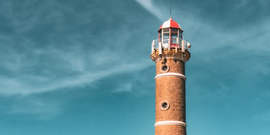 Top International SIPP Providers 2025 Lighthouse under a bright blue sky symbolising clear financial direction for expats