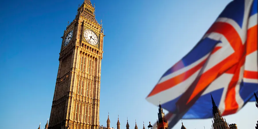 UK Parliament building with UK flag illustrating UK Budget 2025 Class 2 NIC changes for British expats